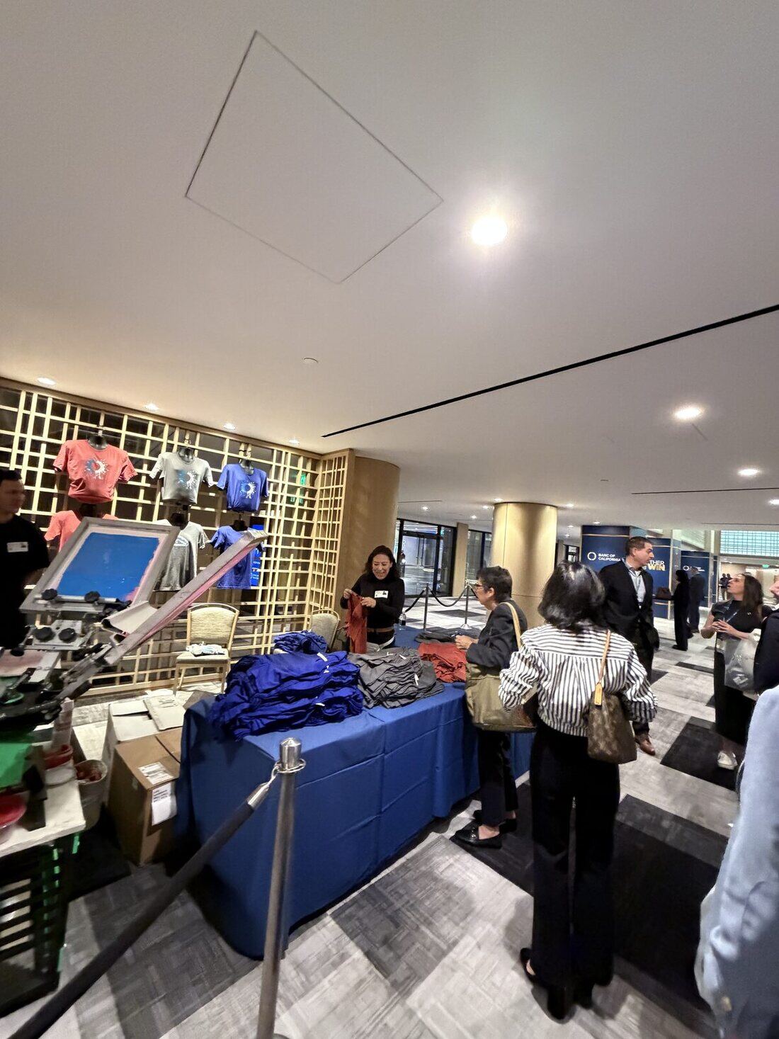 Guests lined up at the live printing booth waiting for their custom pieces